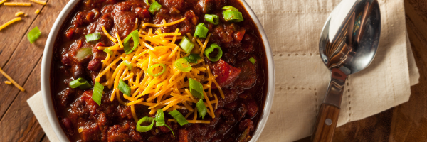 Bowl of chili with spoon and napkin