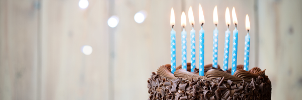 chocolate cake with blue lit candles