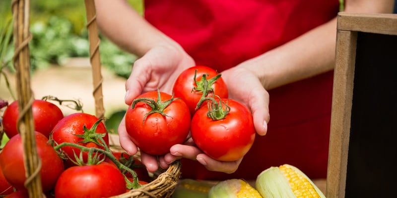 woman holding tomatoes