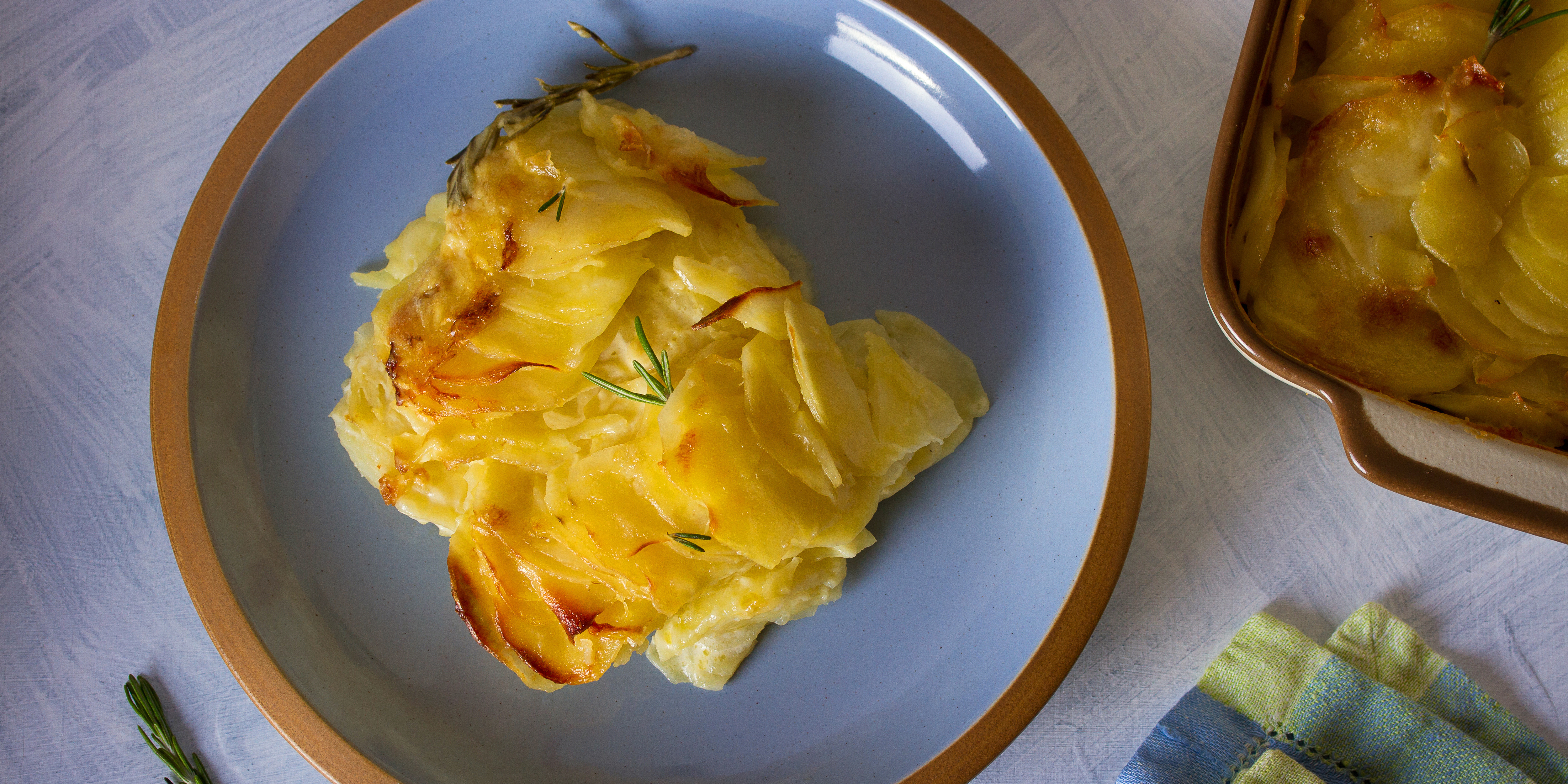 cheesy potatoes on blue plate