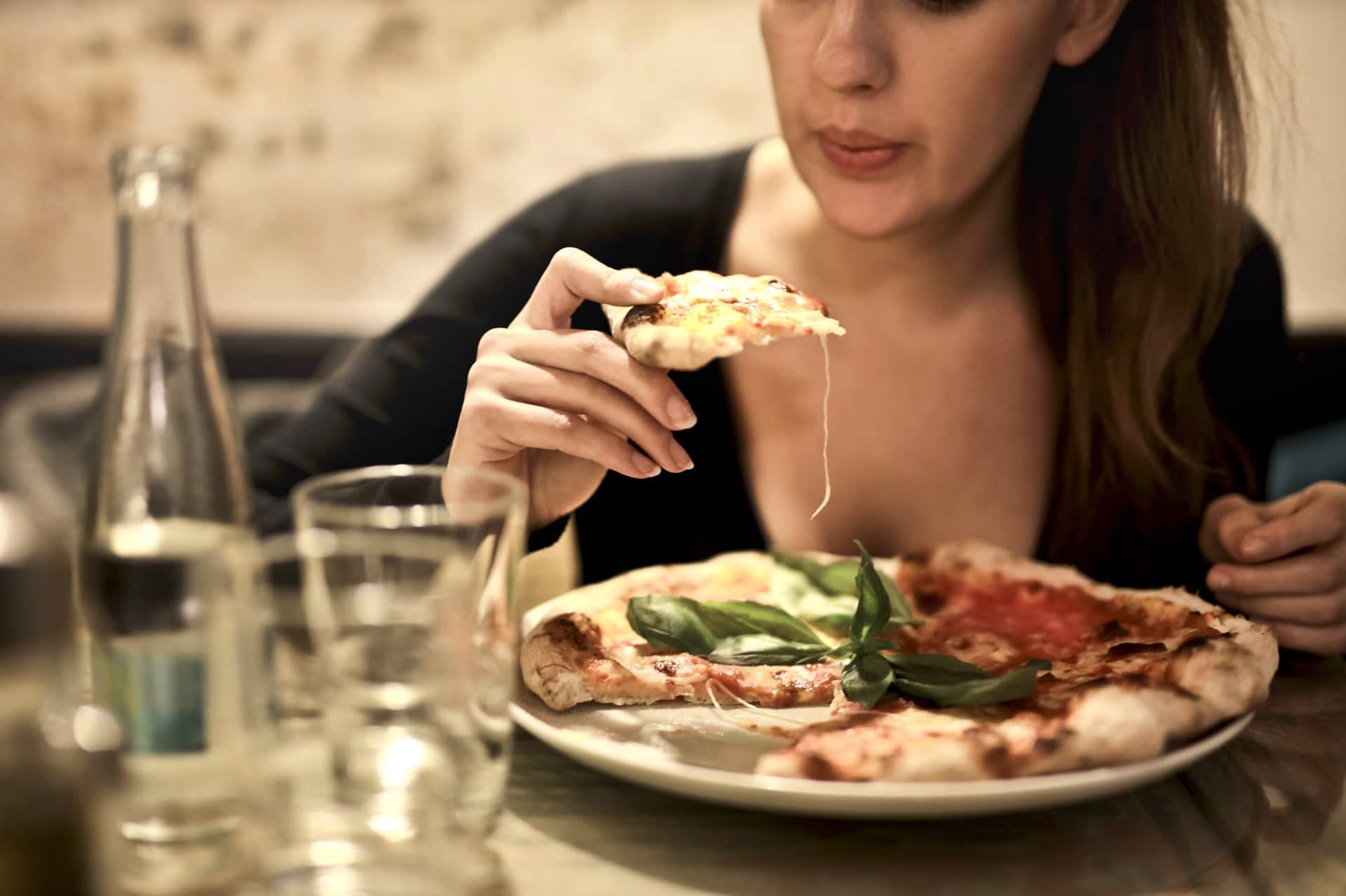 woman eating flatbread pizza